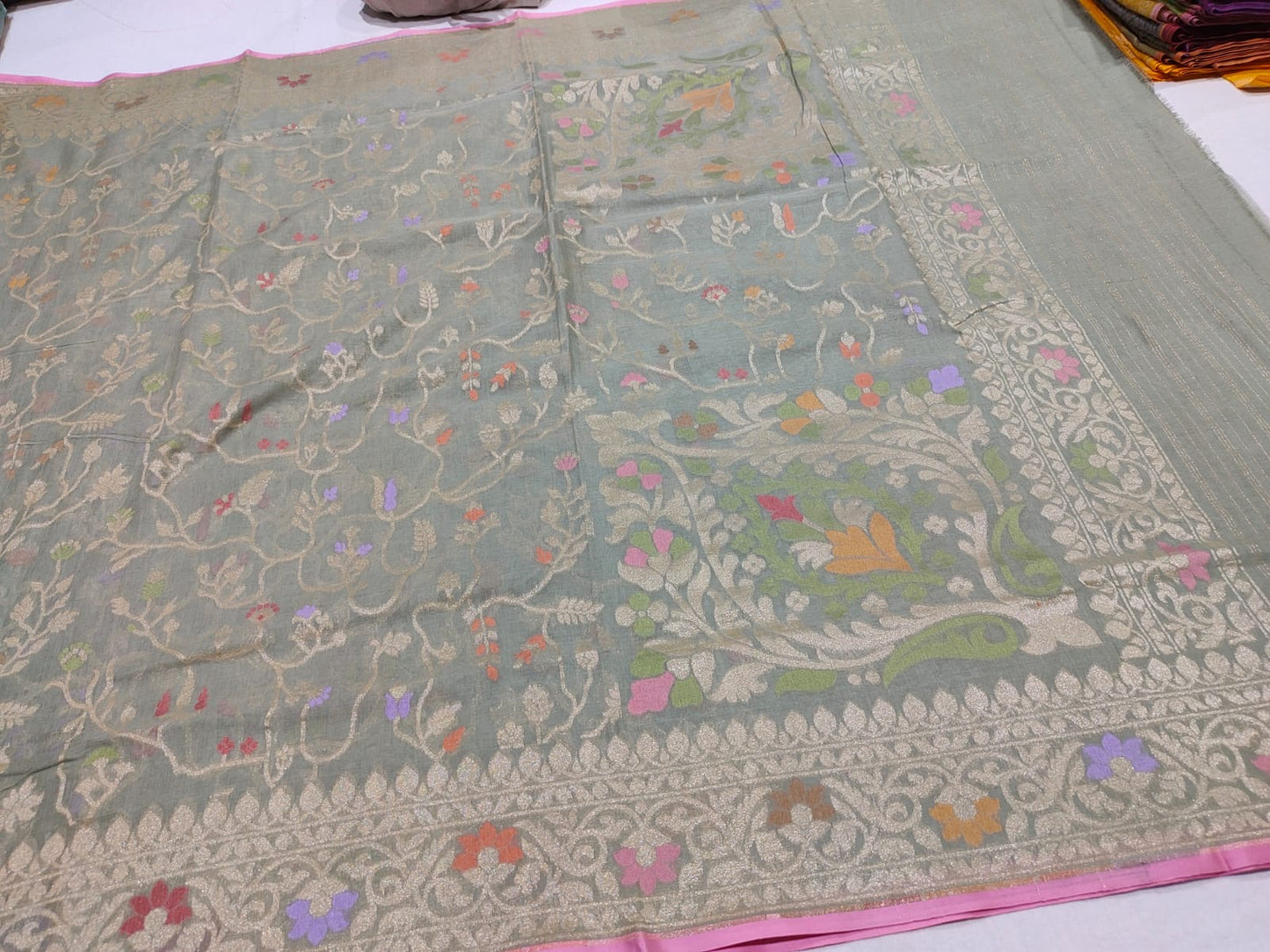 Embroidered fabric with floral patterns on a plain background