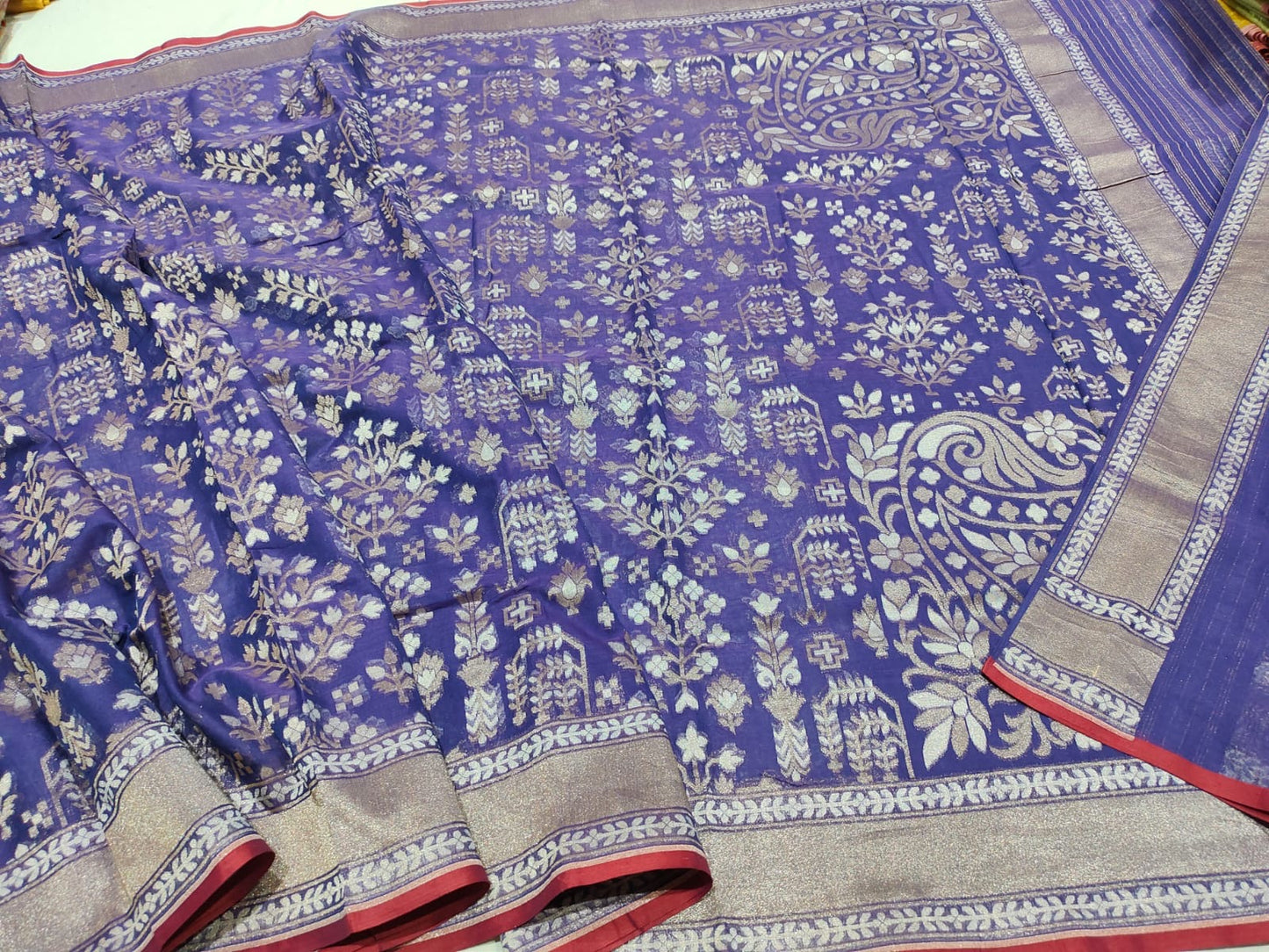Blue saree with white floral patterns on a plain background