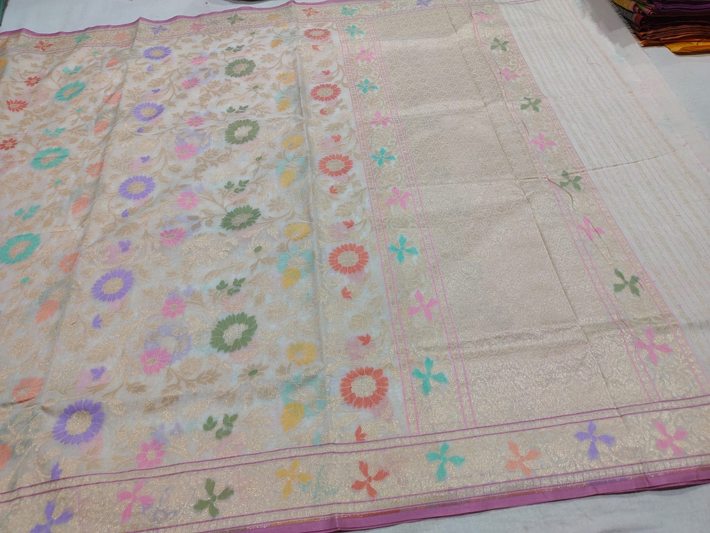 Beige fabric with colorful floral patterns on a white background